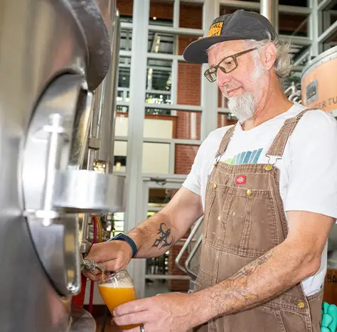 A head brewer at work in the brewhouse